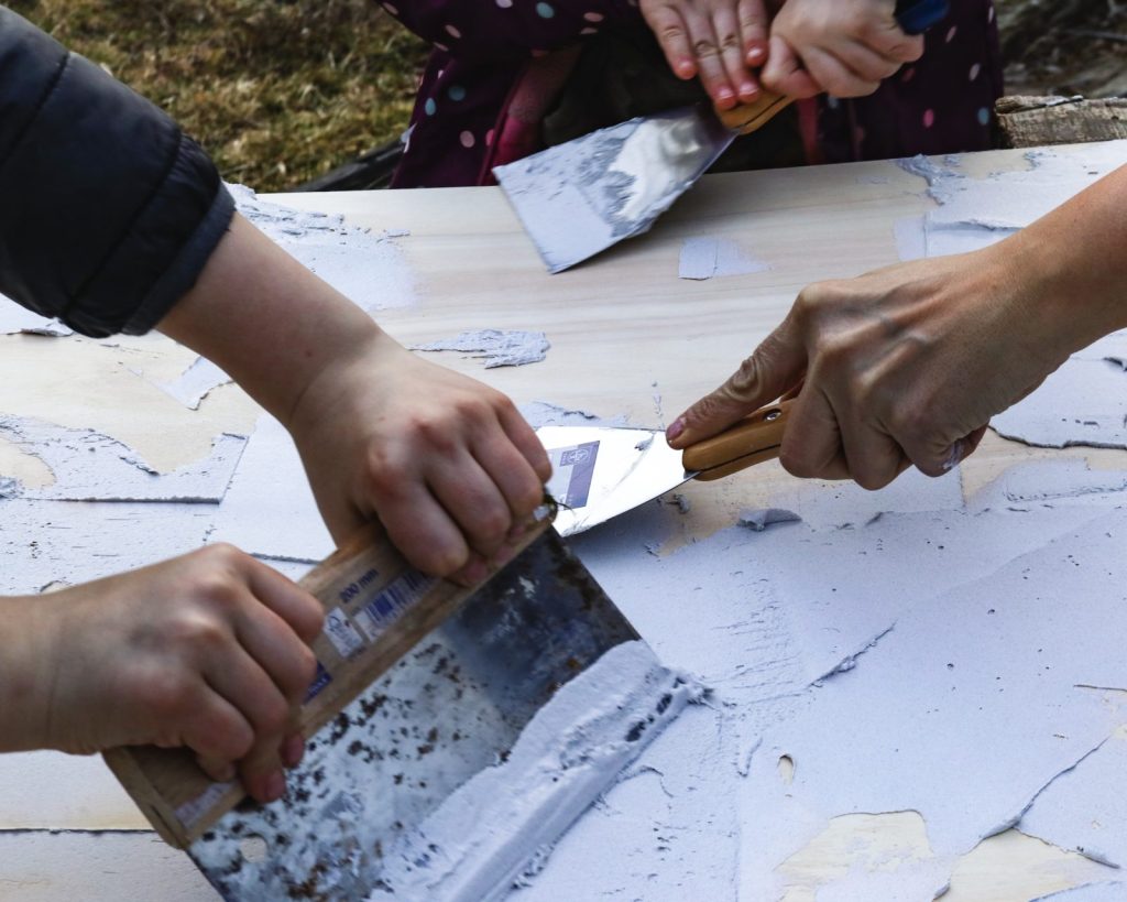 applying joint compound on the plywood for structure