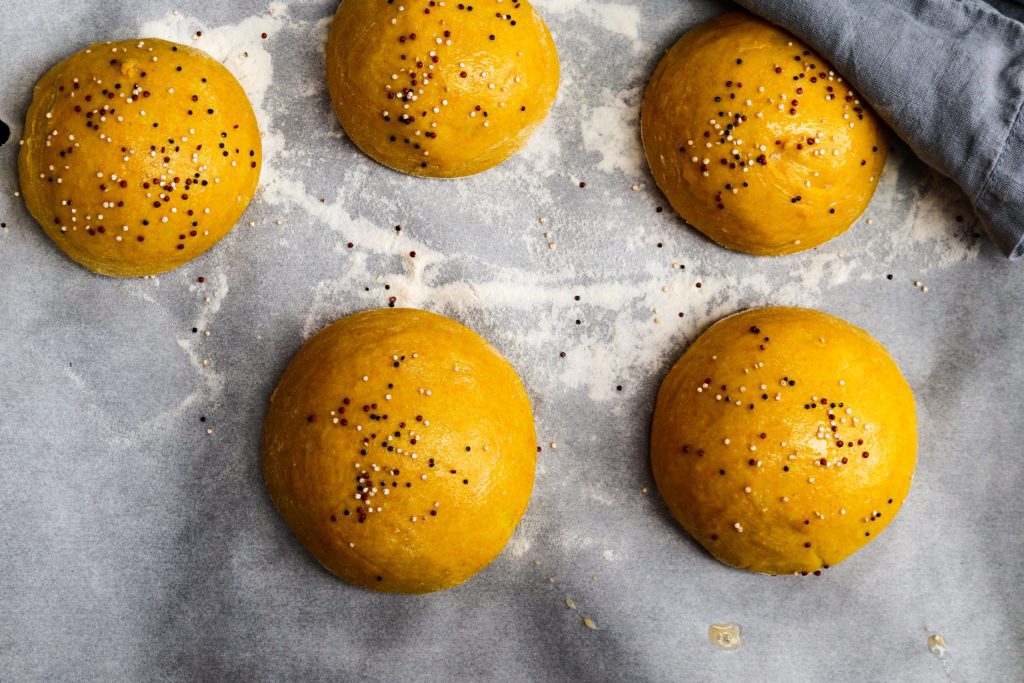 Pillowy turmeric brioche burger buns before baking