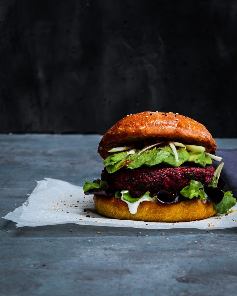 Delicious vegan Red Beet, White Bean &Quinoa Burger with Avocado