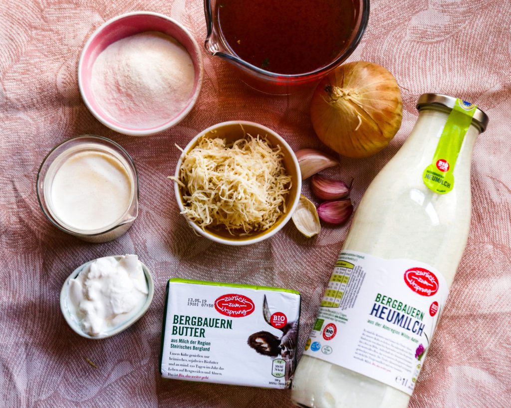 Ingredients for a creamy horseradish soup on a blush pink linen