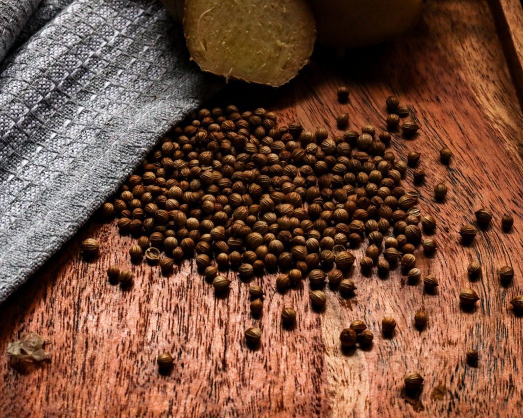 coriander seeds and Ginger root on a wooden underground