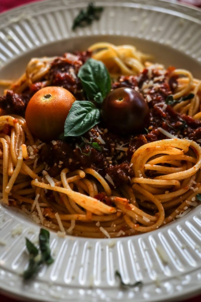 excerpt of the bolognese pasta on a white plate