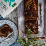 banana bread on baking paper on a brown wooden tablet