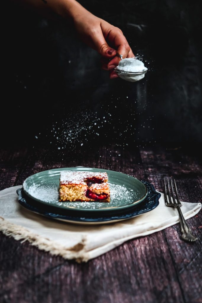 plum sheet cake square on a blue plate