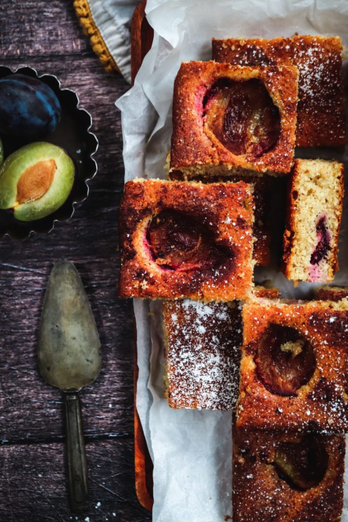 Plum sheet cake squares on a white baking paper