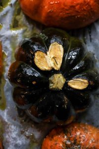 baked pumpkin halves on a baking sheet, pomegranate recipes, pumpkin recipes