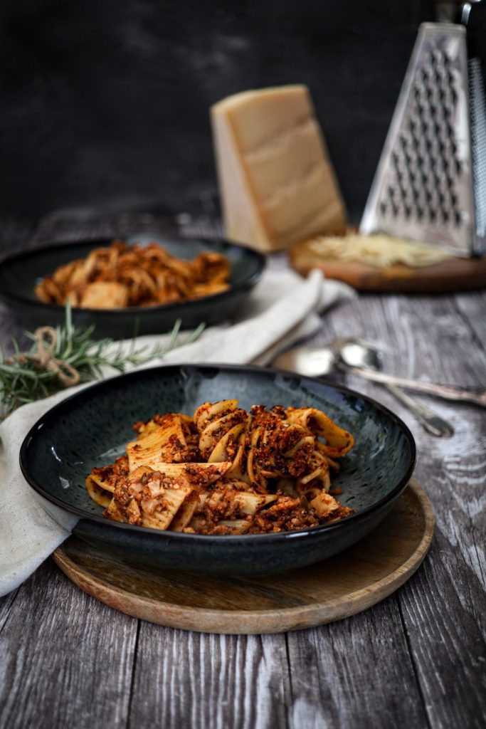 vegetarian cauliflower bolognese served on blue marbled stone plates